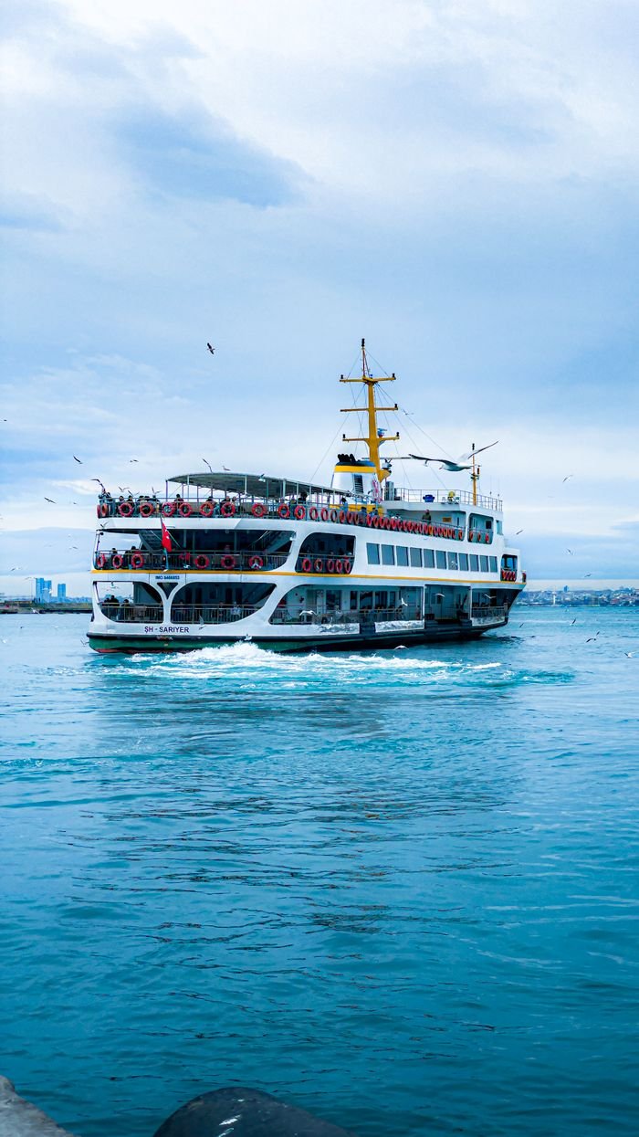 A ferry sails on the Bosphorus in İstanbul, capturing the city's maritime charm.