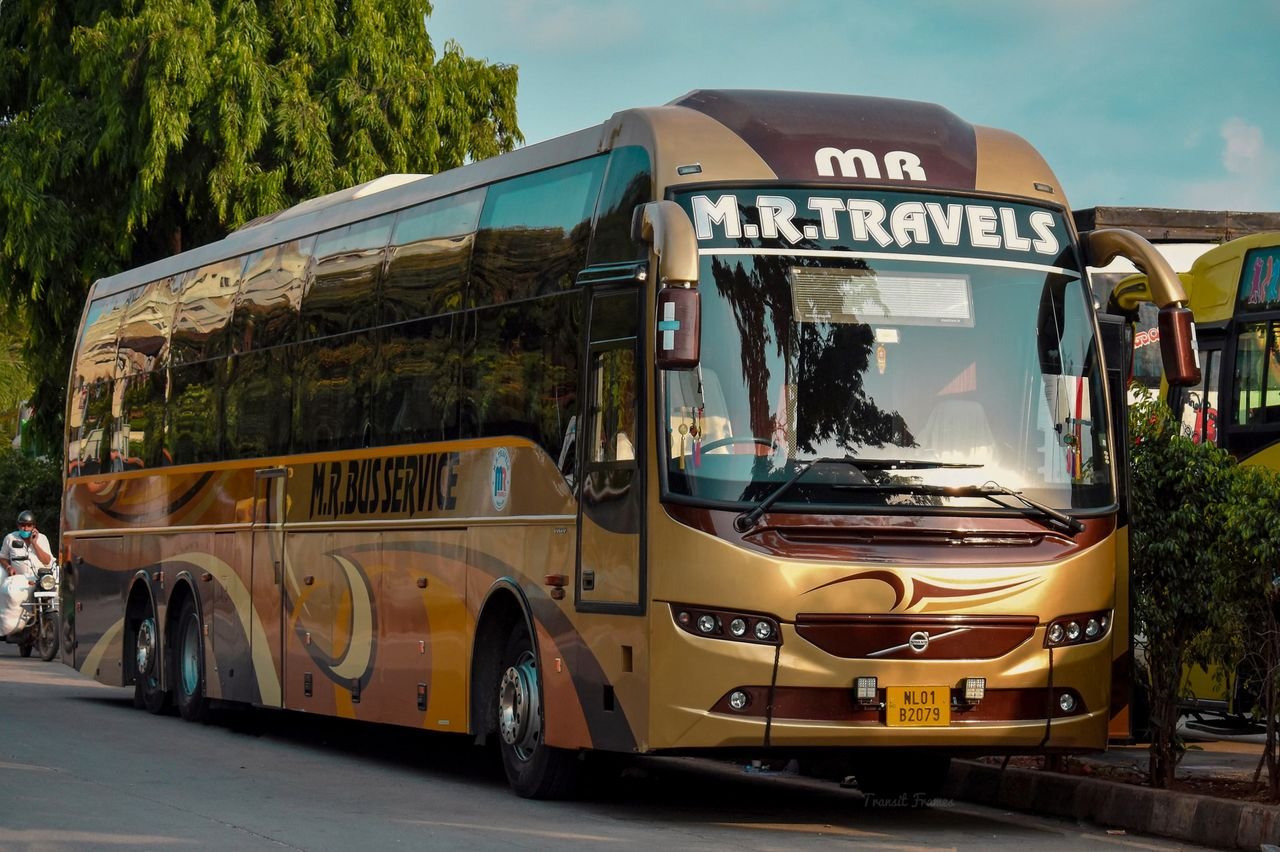 The Art of Drawing Readers In: Your attractive post title goes here Golden luxury tour bus from M.R. Travels parked on street during the day with bright surroundings.